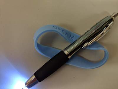 A lighted pen and rubber bracelet are useful for keeping a dream journal.